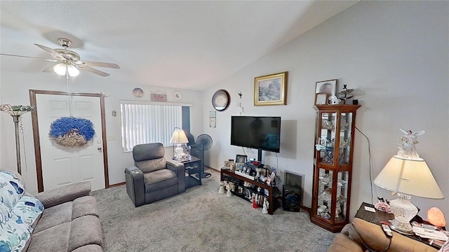 living room with lofted ceiling, ceiling fan, and carpet