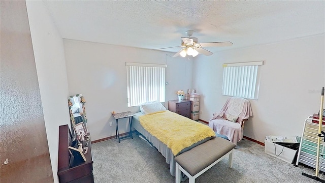 carpeted bedroom with a textured ceiling and ceiling fan