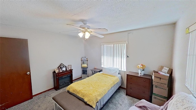 carpeted bedroom featuring a textured ceiling and ceiling fan