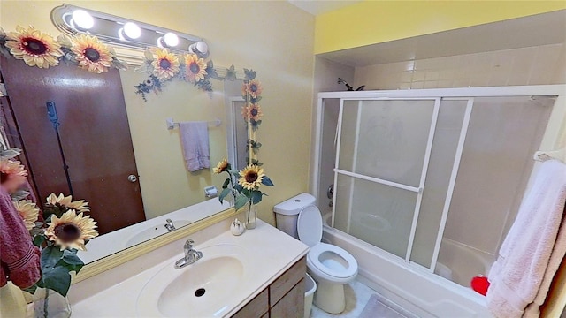 full bathroom with tile patterned floors, vanity, toilet, and combined bath / shower with glass door