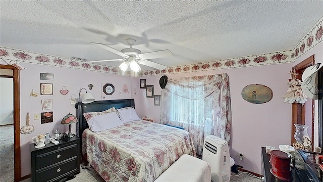 carpeted bedroom featuring a textured ceiling and ceiling fan