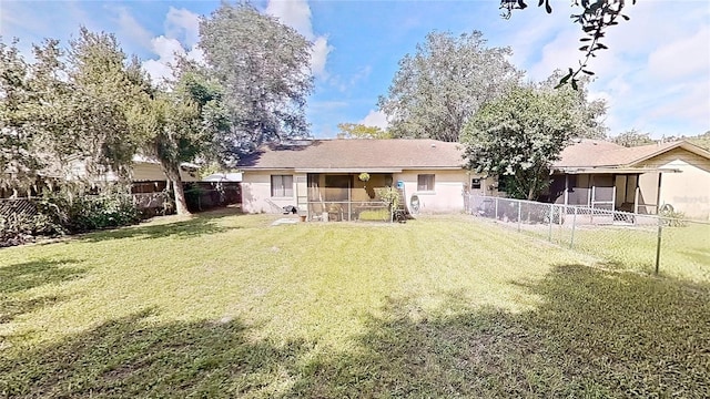 rear view of house featuring a yard