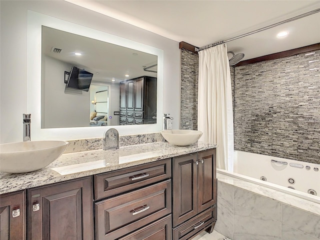 bathroom featuring vanity and shower / bathtub combination with curtain