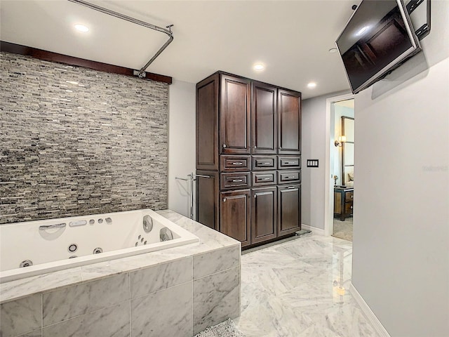 bathroom with tiled bath