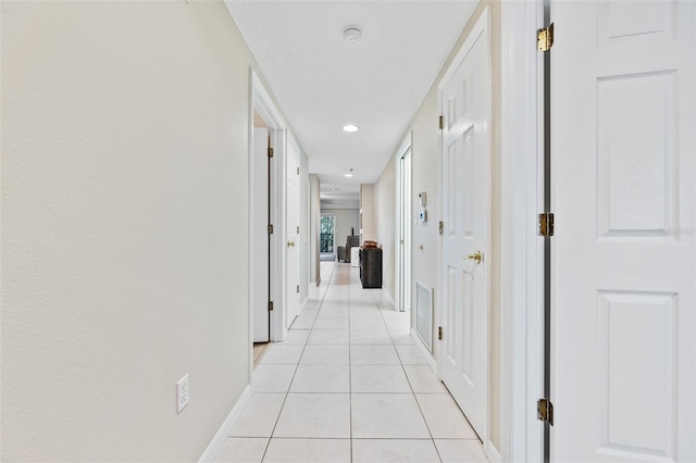 hallway featuring light tile patterned flooring