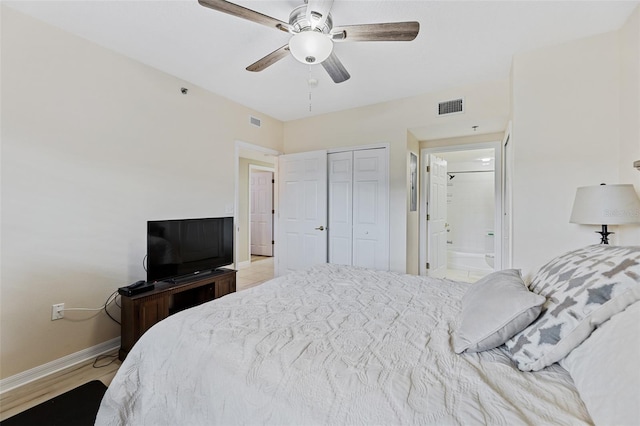 bedroom with light hardwood / wood-style floors, ceiling fan, and a closet