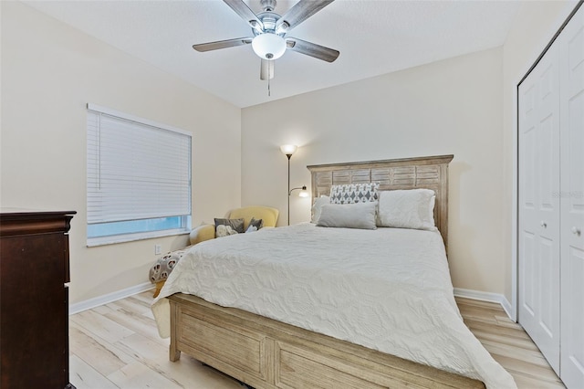 bedroom with ceiling fan, a closet, and light hardwood / wood-style floors