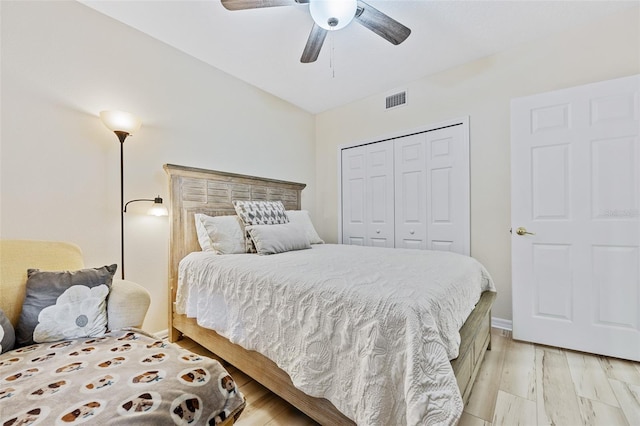 bedroom featuring ceiling fan, a closet, and light wood-type flooring