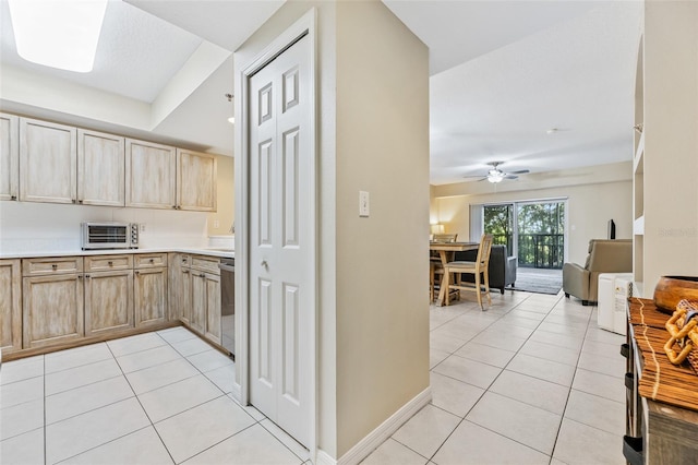 kitchen with dishwasher, ceiling fan, light brown cabinetry, and light tile patterned flooring