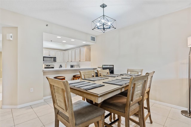 dining room with light tile patterned floors, a chandelier, and a textured ceiling