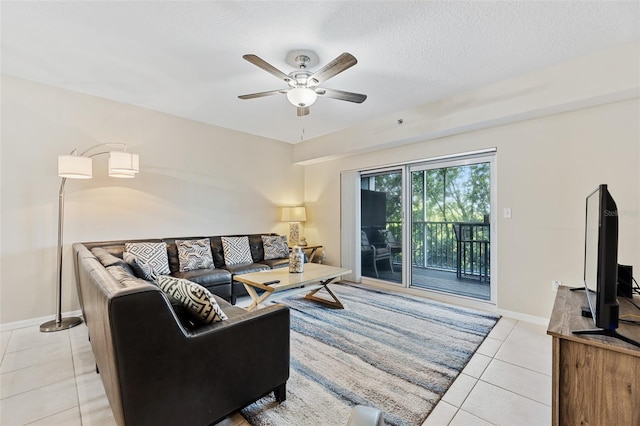 tiled living room featuring a textured ceiling and ceiling fan