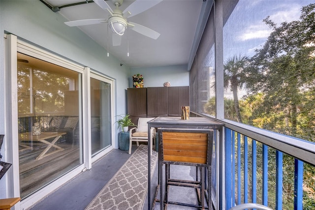 sunroom featuring ceiling fan