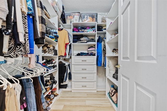 walk in closet with light wood-type flooring