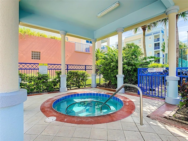 view of swimming pool featuring a hot tub