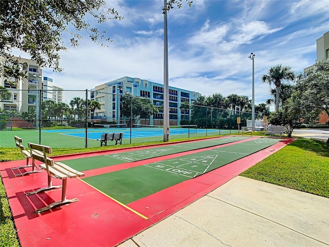 view of community featuring tennis court