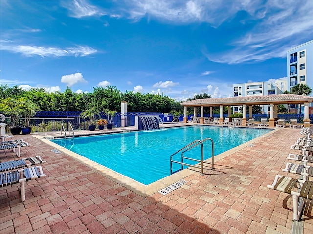 view of swimming pool with pool water feature