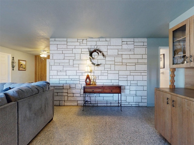 interior space featuring a textured ceiling and ceiling fan