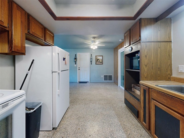 kitchen with ceiling fan, range with electric stovetop, and white refrigerator