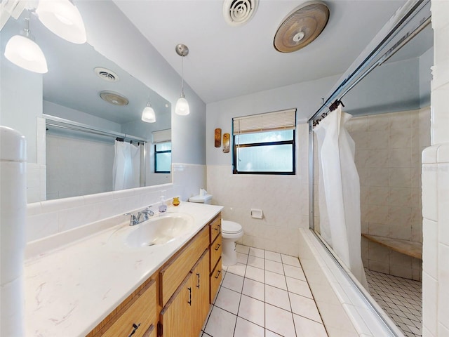 bathroom with a shower with shower curtain, vanity, toilet, and plenty of natural light