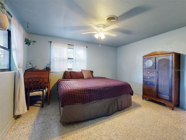 bedroom with a textured ceiling and ceiling fan