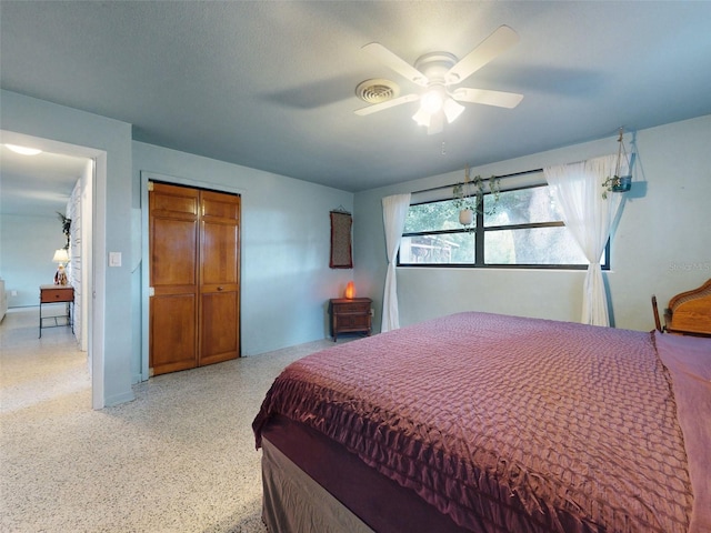 bedroom featuring a closet, ceiling fan, and a textured ceiling