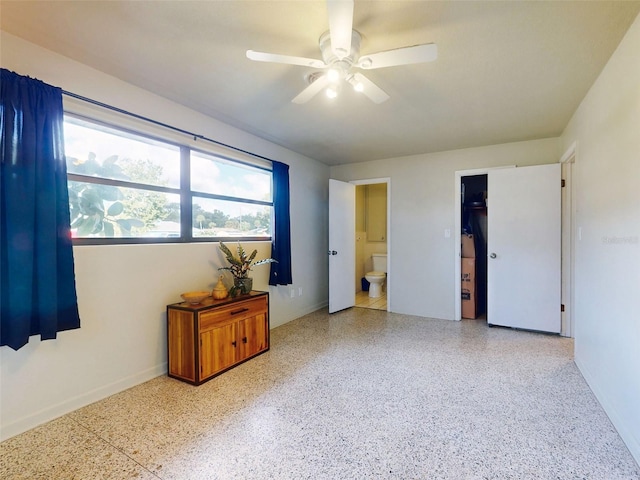 bedroom featuring ceiling fan and ensuite bathroom