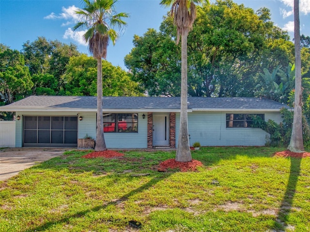 single story home featuring a garage and a front lawn