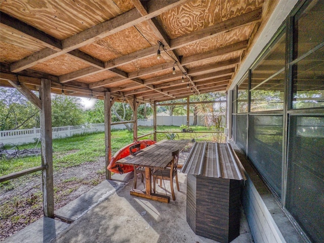 unfurnished sunroom with a wealth of natural light and lofted ceiling