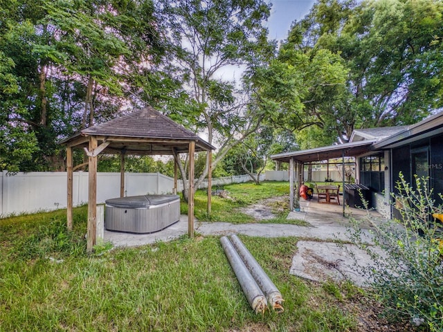 view of yard with a hot tub, a patio, and a gazebo