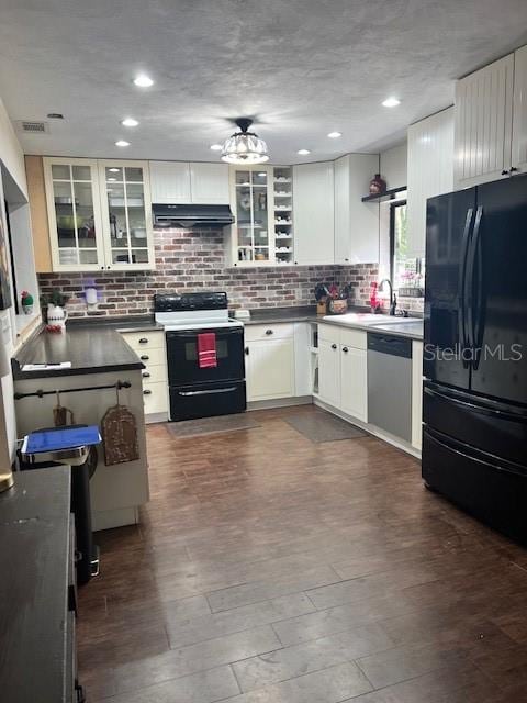 kitchen with dishwasher, dark hardwood / wood-style flooring, white cabinetry, black refrigerator, and range with electric stovetop