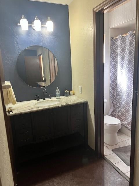 bathroom with vanity, toilet, curtained shower, and tile patterned floors