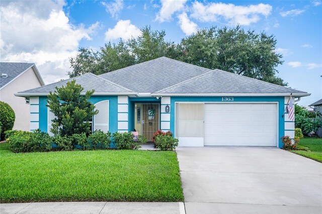 ranch-style home with a front yard and a garage