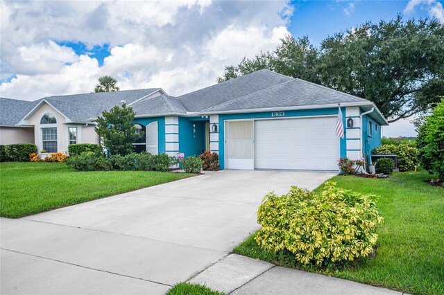 single story home with a front yard and a garage