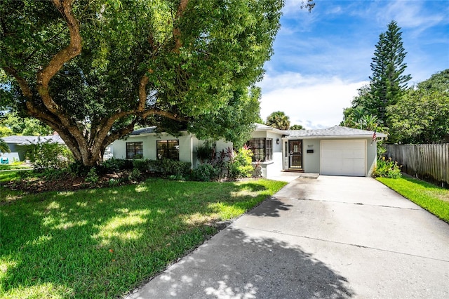 view of front of home with a front lawn and a garage