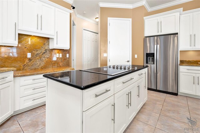 kitchen featuring dark stone counters, stainless steel fridge with ice dispenser, white cabinets, electric stovetop, and light tile patterned floors