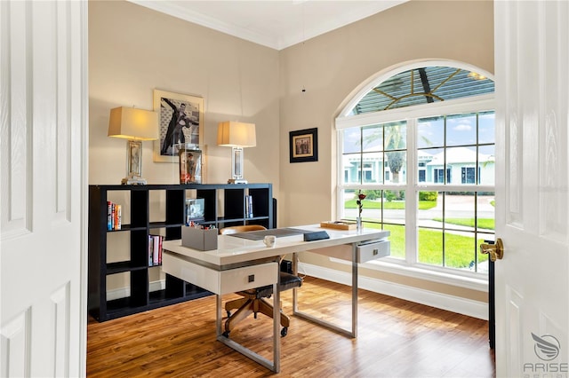 home office with wood-type flooring and ornamental molding