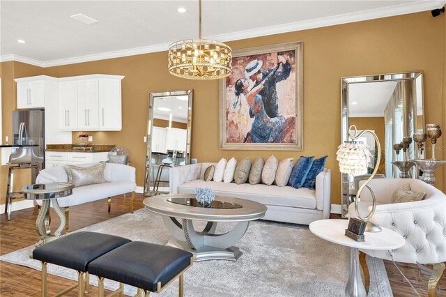 living room with crown molding, dark hardwood / wood-style flooring, and a notable chandelier