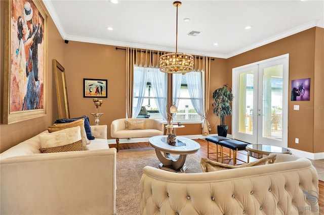 living room with french doors, crown molding, and a chandelier