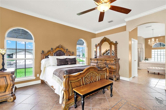 tiled bedroom with ceiling fan with notable chandelier, ensuite bath, multiple windows, and ornamental molding