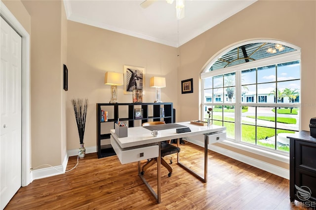 home office with ornamental molding, ceiling fan, and hardwood / wood-style floors