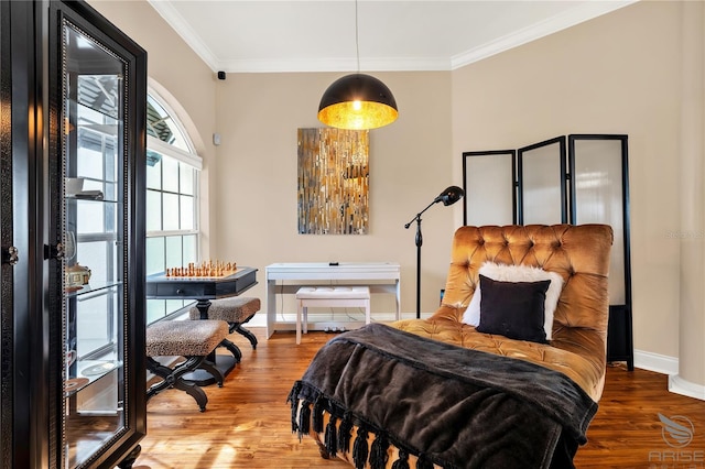 bedroom featuring baseboards, ornamental molding, and wood finished floors