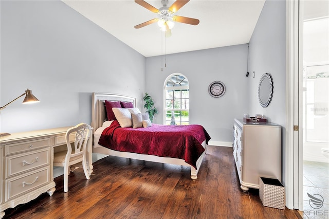 bedroom featuring connected bathroom, ceiling fan, and dark wood-type flooring