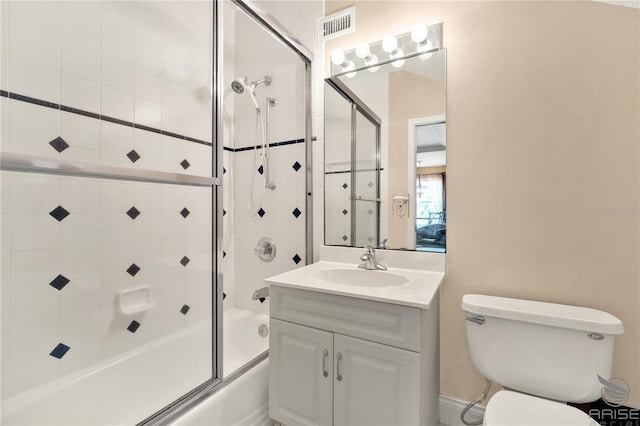 full bathroom with toilet, vanity, bath / shower combo with glass door, and visible vents