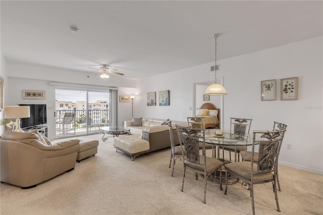 carpeted dining area featuring ceiling fan