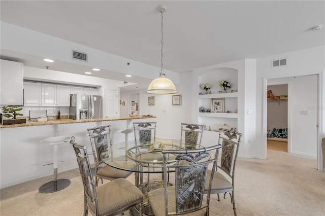 carpeted dining area with built in features