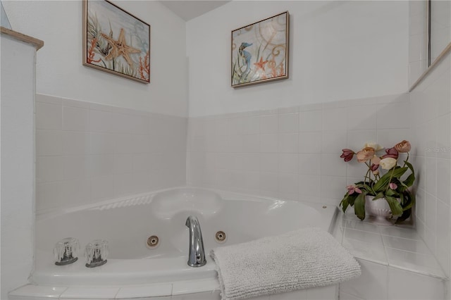 bathroom with a relaxing tiled tub