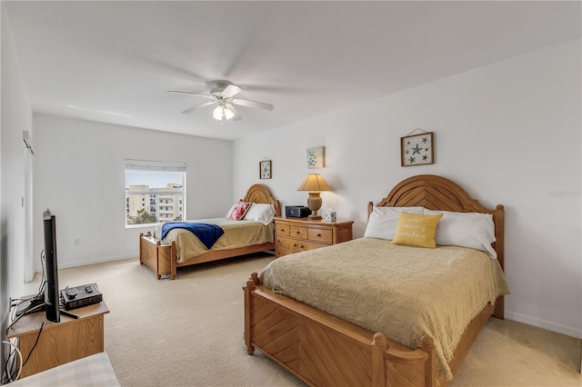 bedroom featuring ceiling fan and light carpet