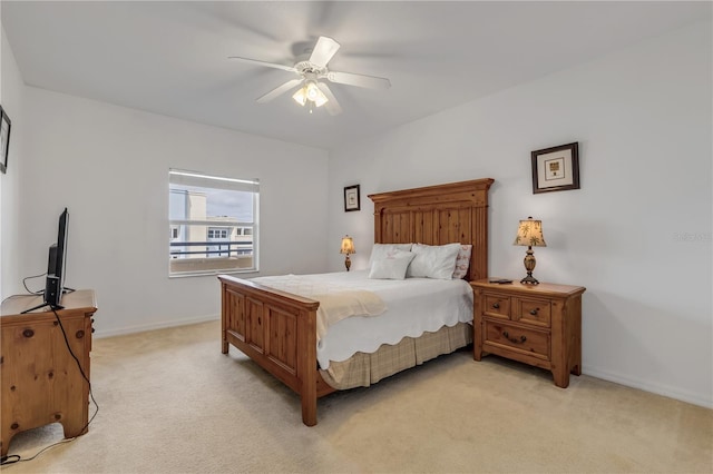 bedroom featuring light carpet and ceiling fan