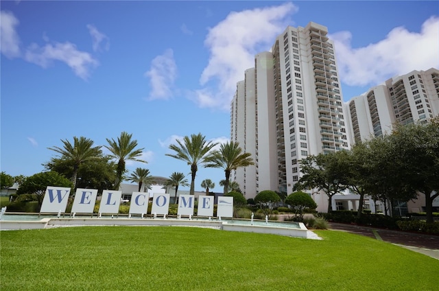 view of community with a swimming pool and a lawn