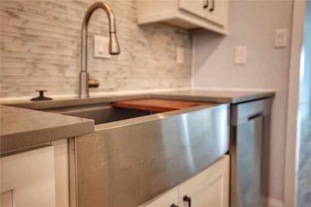 interior space with decorative backsplash and white cabinetry